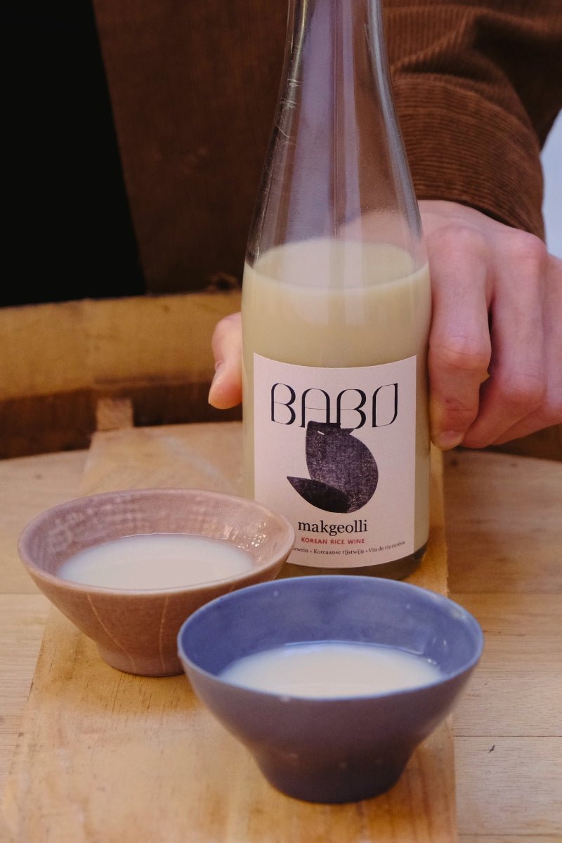 Bottle of Babo Makgeolli with two glasses ready for serving.