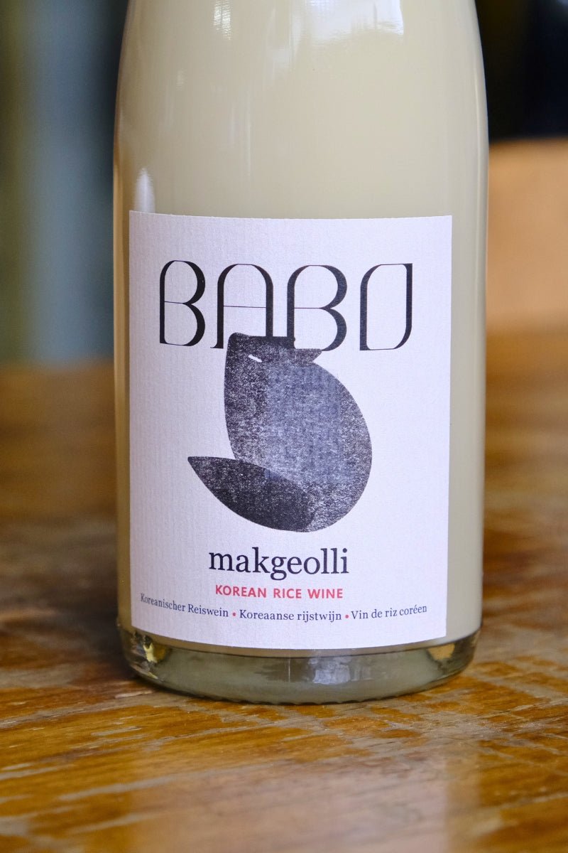 Close-up of the front label on a bottle of Babo Makgeolli, showcasing the branding and design.